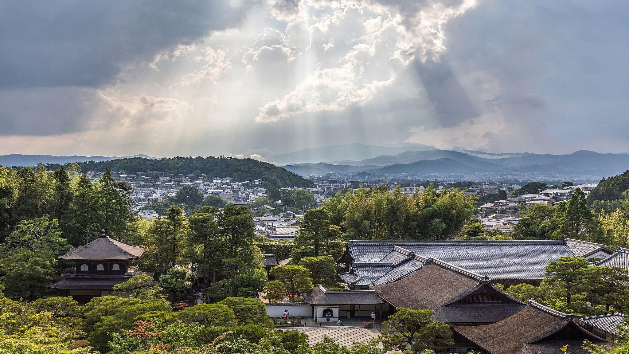 Sunlight through clouds and view of Ginkaku-ji Temple from above, Kyoto, Japan